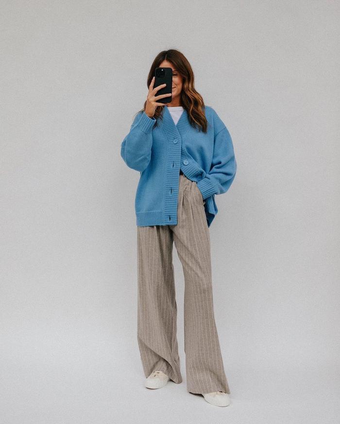 6 cool transitional outfits: @kimturkington_ wearing a relaxed cardigan, wide-leg trousers and trainers
