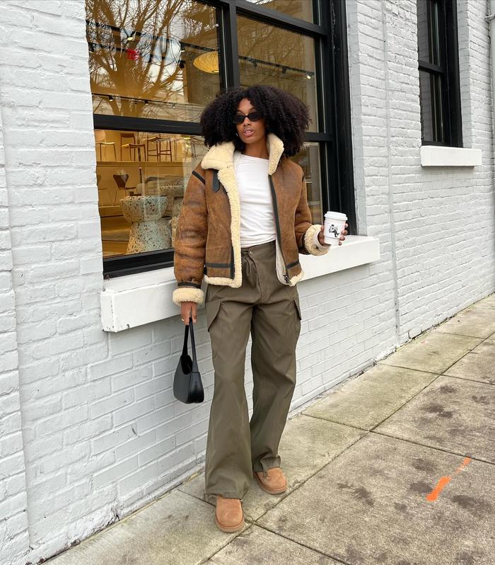 6 cool transitional outfits: Aniya Morinia wearing striped shirt and trousers