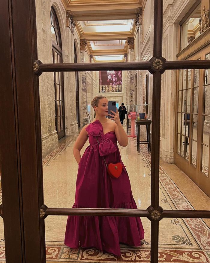 Wedding guest outfit trends 2023: @oliviamarcus wears a rasberry maxi dress