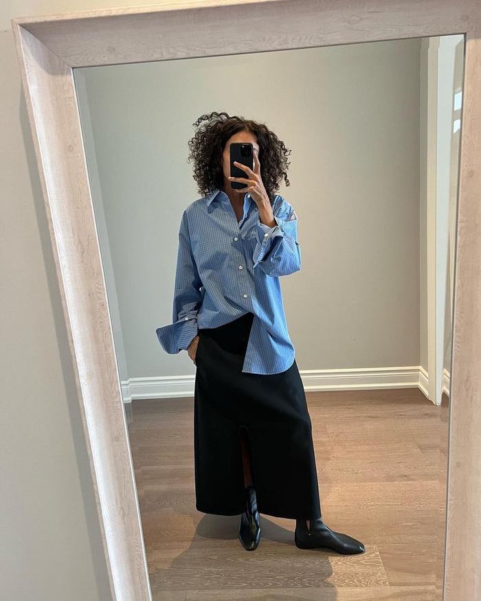 8 Midi-Skirt Outfits Fashion People Are Wearing Now: @neelam.ahooja wears a tailored midi skirt and pinstriped shirt
