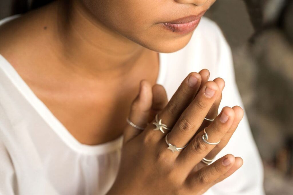 a close-up of a beautiful woman doing yoga and peacefully thinking about things to release for peace of mind