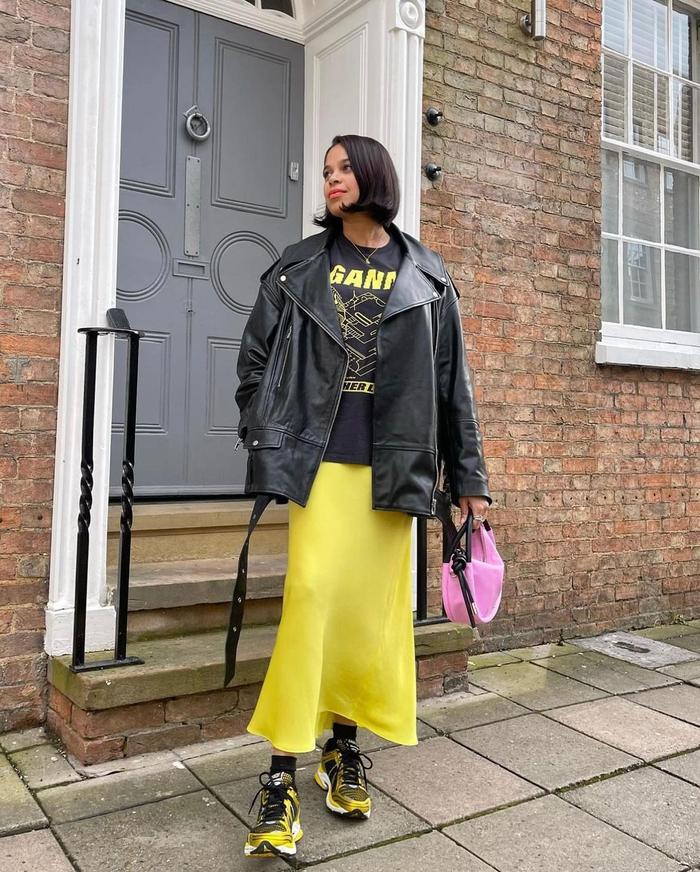 8 Midi-Skirt Outfits Fashion People Are Wearing Now: @catlpatterson wears a satin midi skirt and a leather jacket